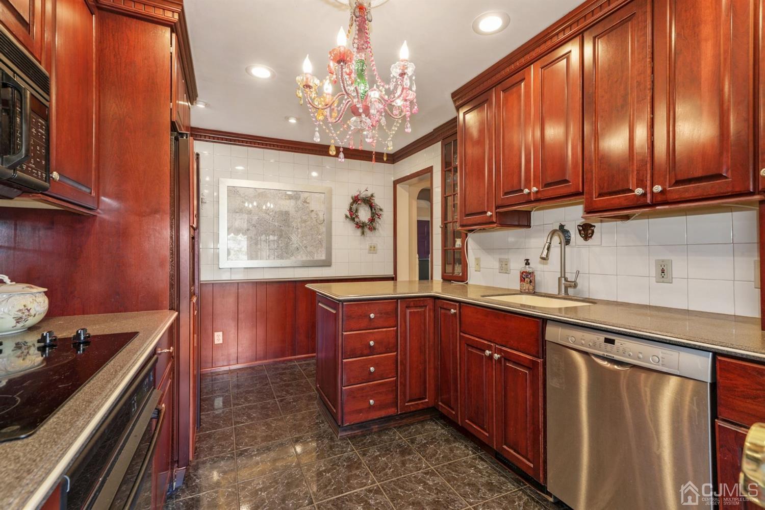 424 Chain O' Hills Road Colonia, NJ 07067 - Photo 21 of 36 a kitchen with wooden cabinets and stove
