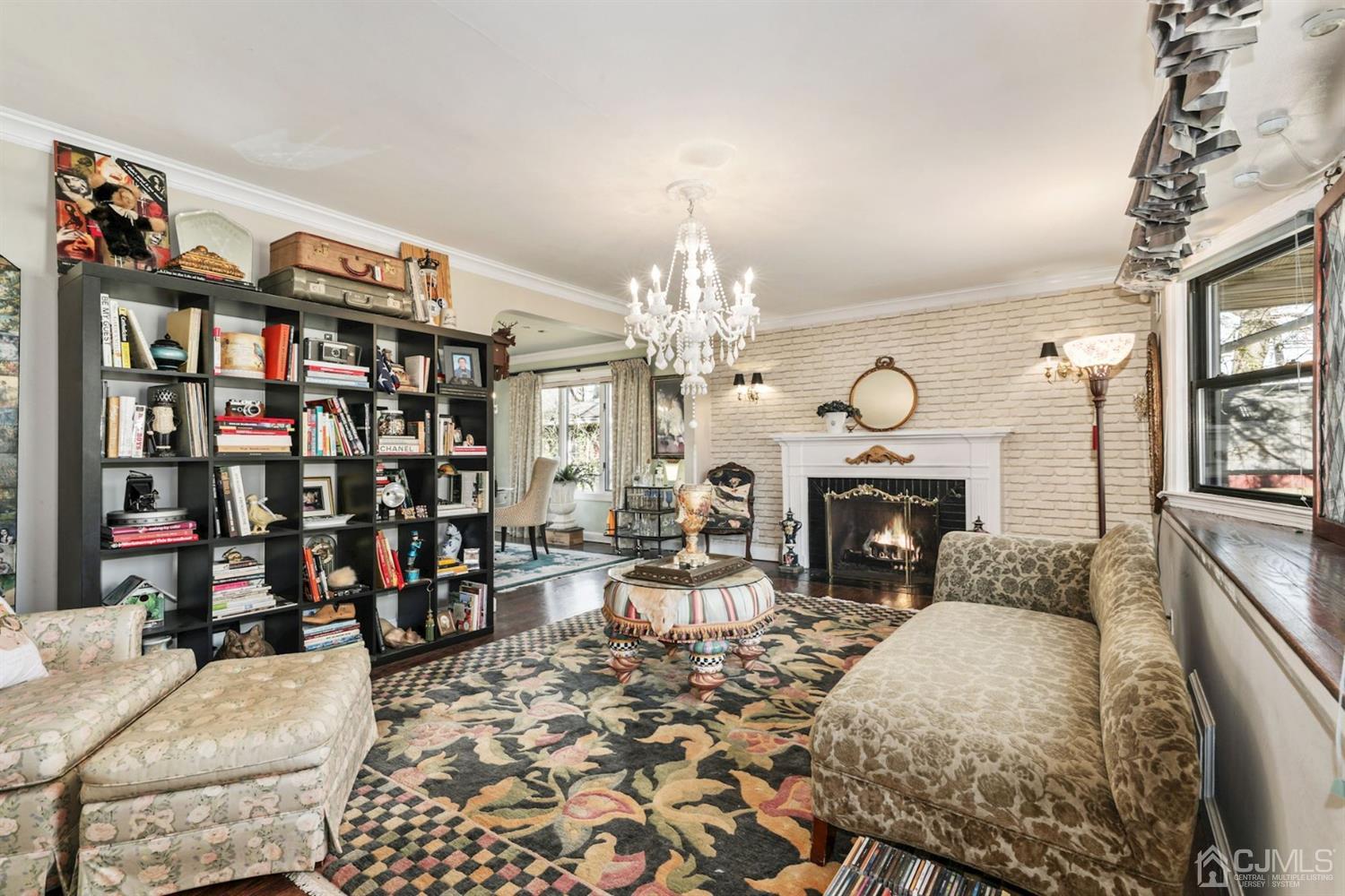 424 Chain O' Hills Road Colonia, NJ 07067 - Photo 25 of 36 a living room with furniture a fireplace and a chandelier