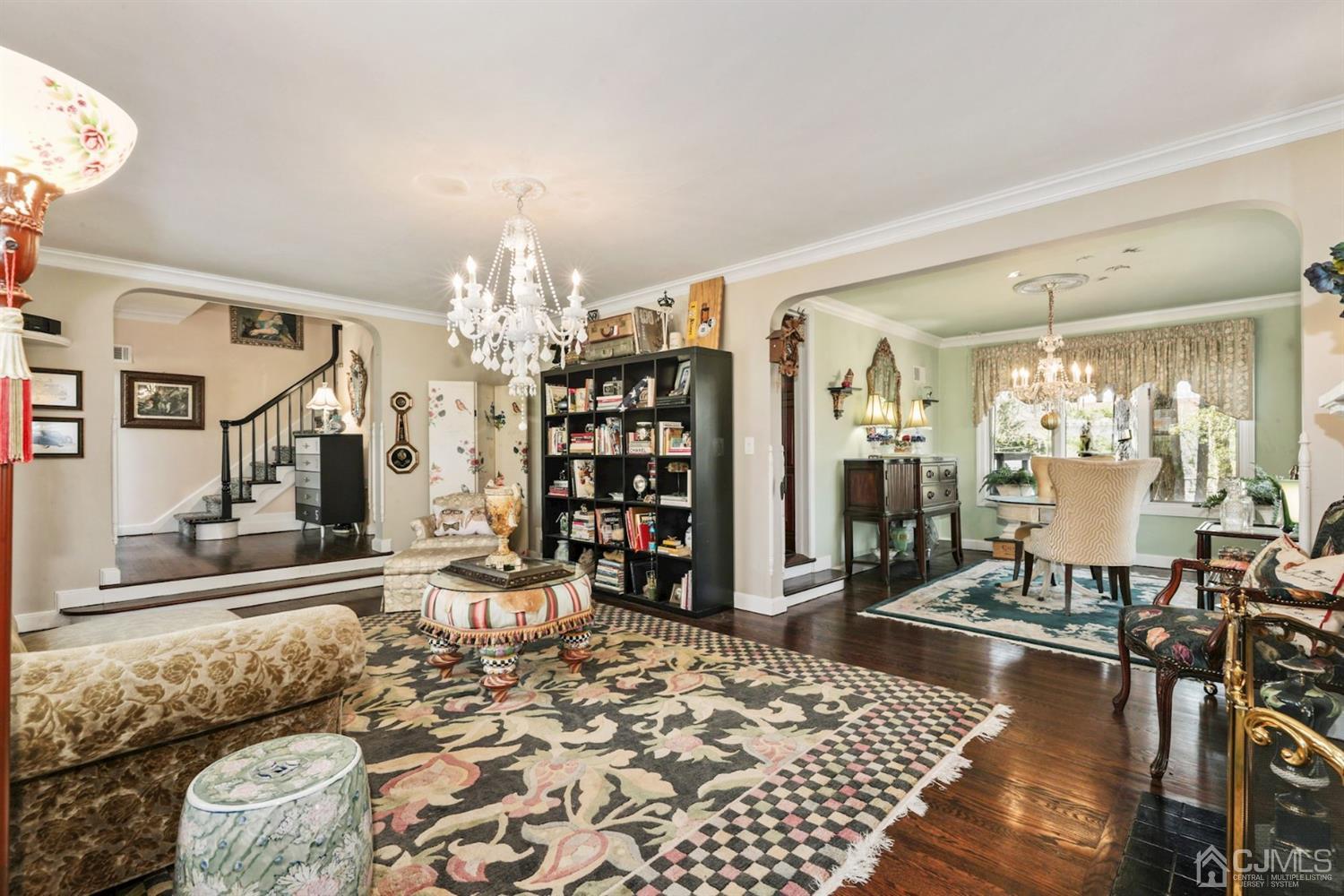 424 Chain O' Hills Road Colonia, NJ 07067 - Photo 26 of 36 a living room with furniture a rug and a chandelier