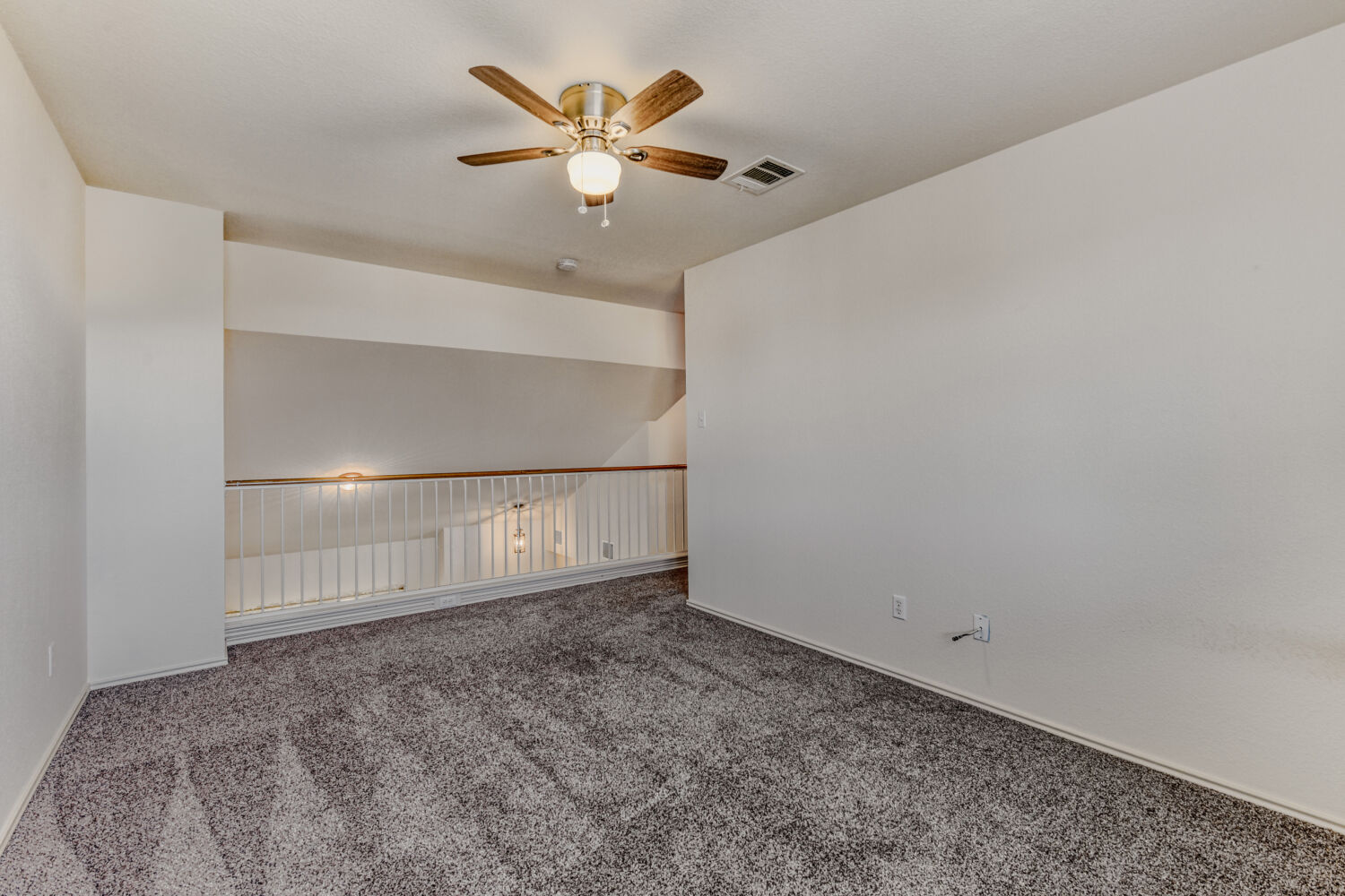 14716 Lipton Lane Pflugerville, TX 78660 - Photo 14 of 26 an empty room with a chandelier fan and wooden floor