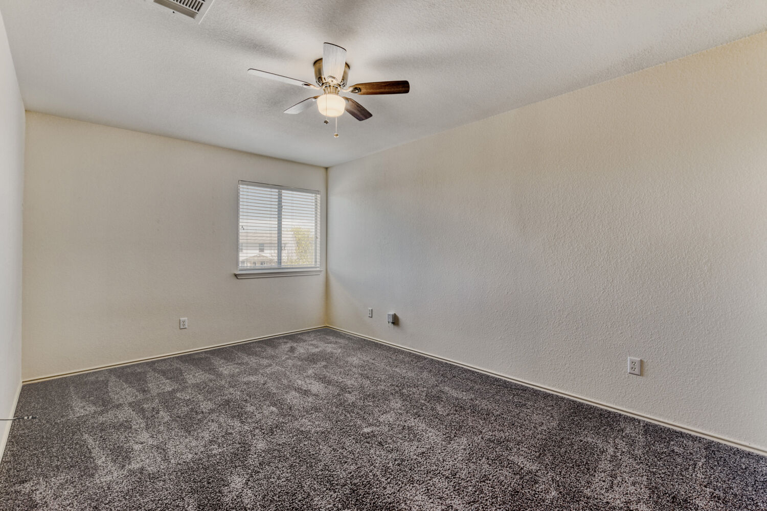 14716 Lipton Lane Pflugerville, TX 78660 - Photo 15 of 26 an empty room with windows and fan