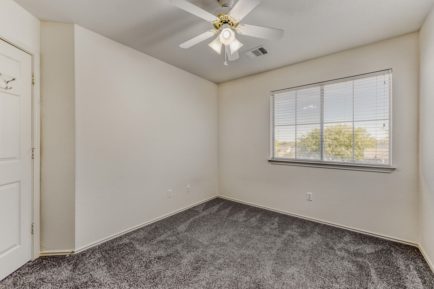 14716 Lipton Lane Pflugerville, TX 78660 - Photo 20 of 26 an empty room with a window and a fan
