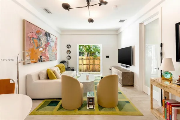 a living room with furniture and a flat screen tv