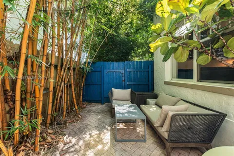 a view of a backyard with a table and chair and wooden fence