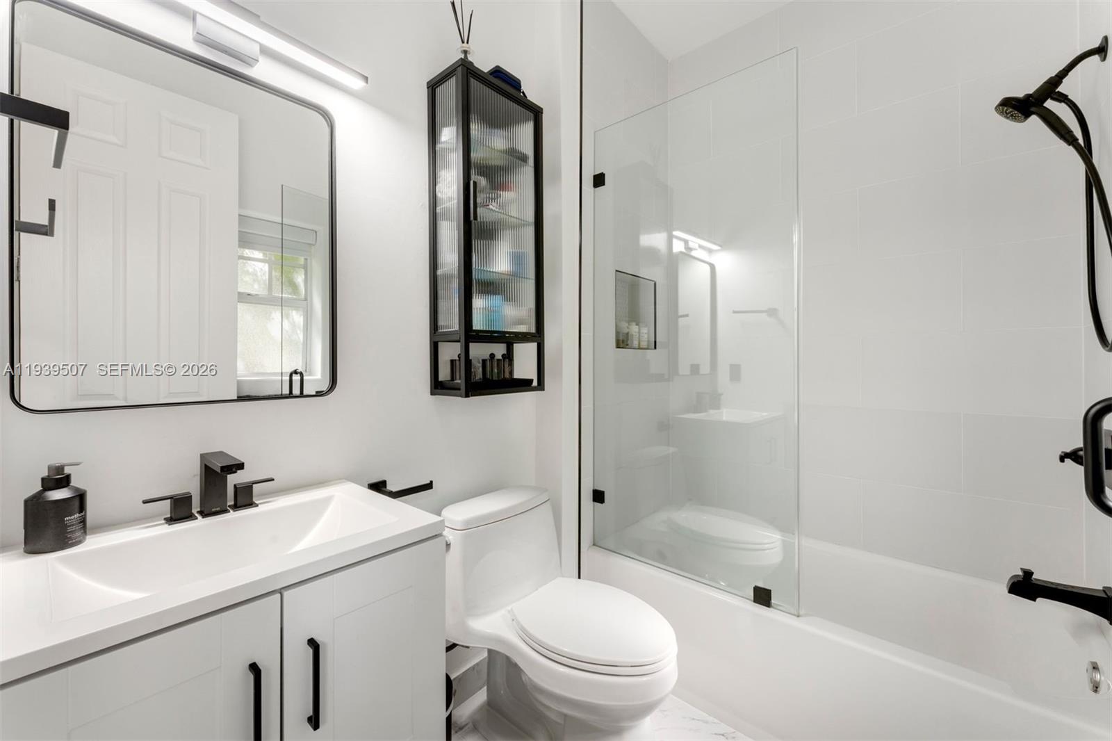 1045 Michigan Avenue, Unit B Miami Beach, FL 33139 - Photo 8 of 15 a bathroom with a sink toilet vanity and shower