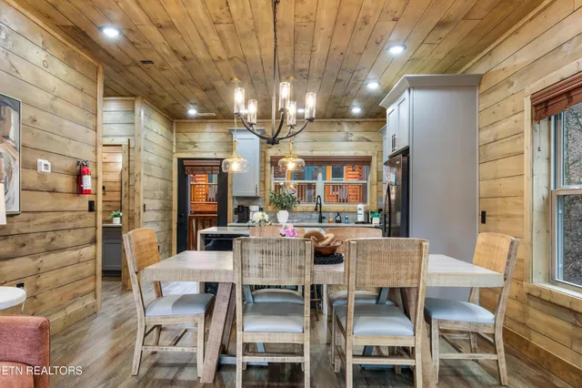 a dining room with furniture and a chandelier