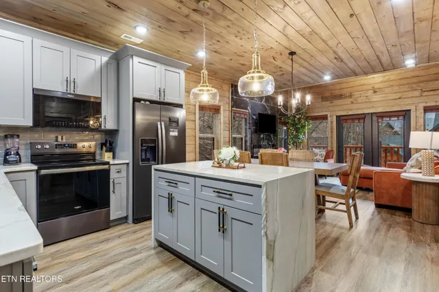 a kitchen with a sink refrigerator and microwave