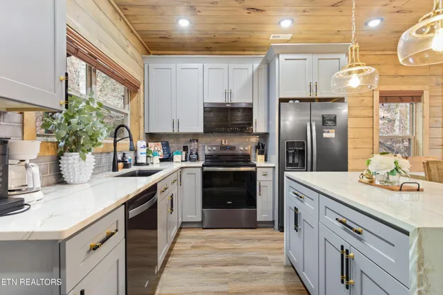 a kitchen with a sink and a stove top oven