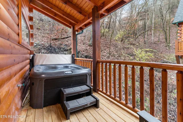 a large bedroom with a bed and wooden floor