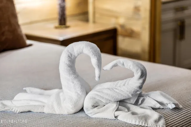 a bedroom with a bed window and a flat screen tv