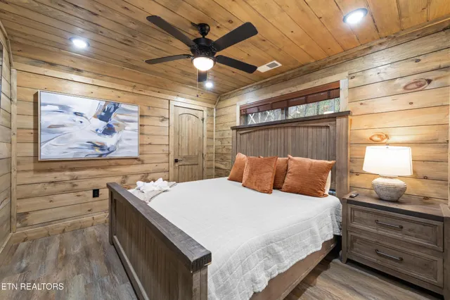 a bedroom with a bed and a large window