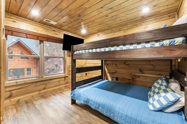 an aerial view of a house with a yard and trees