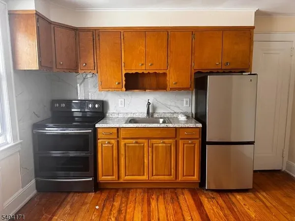 a kitchen with stainless steel appliances granite countertop a refrigerator and a stove top oven