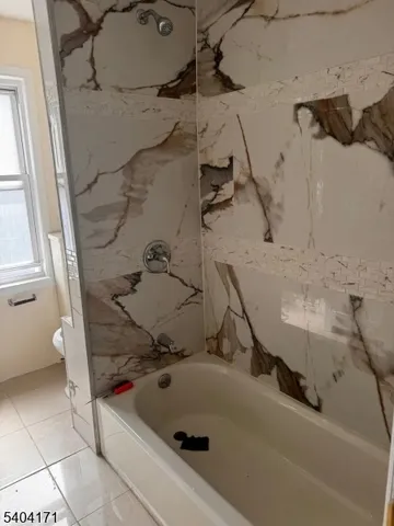 a bath tub sitting next to a sink