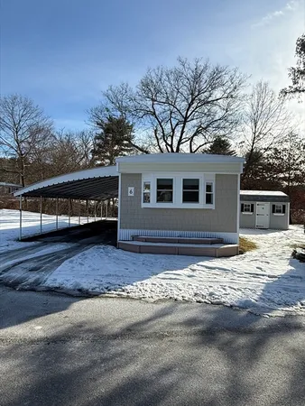 a view of a house with a snow on the road