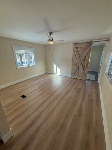 wooden floor in an empty room with a window