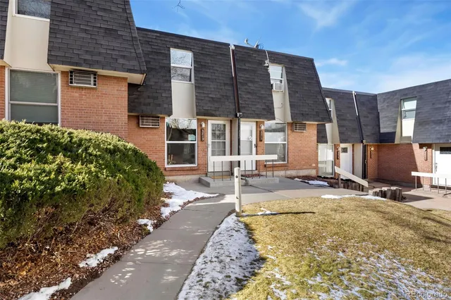 a view of a backyard with table and chairs under an umbrella