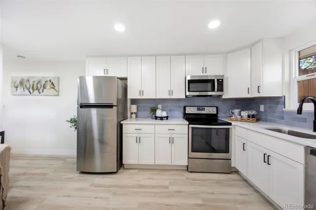 a kitchen with stainless steel appliances a stove microwave and a refrigerator