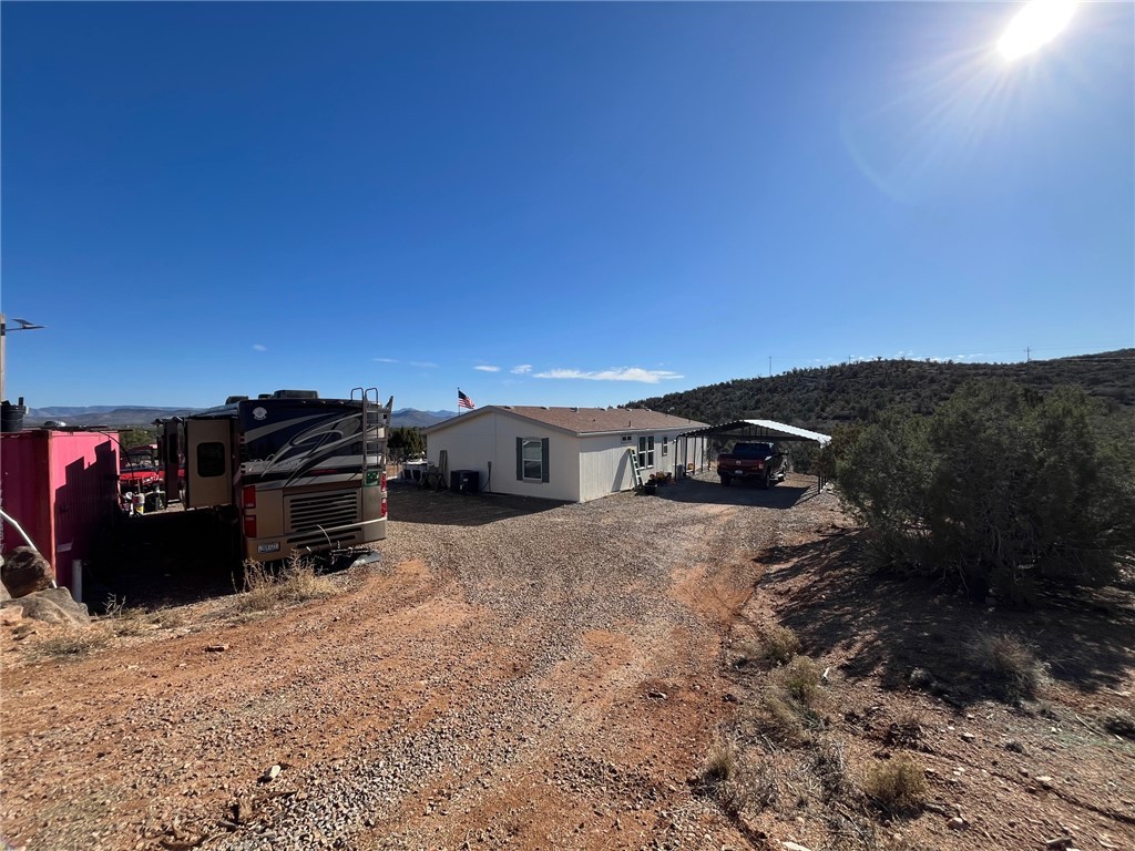 9918 East Blake Ranch Road Kingman, AZ 86401 - Photo 21 of 26 Back of house with dirt driveway