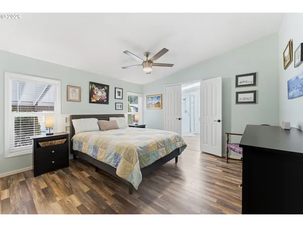 a spacious bedroom with a bed and a desk