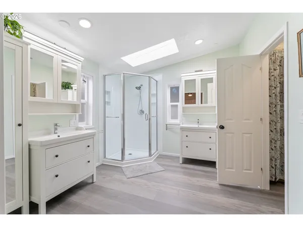 a bathroom with a double vanity sink mirror and