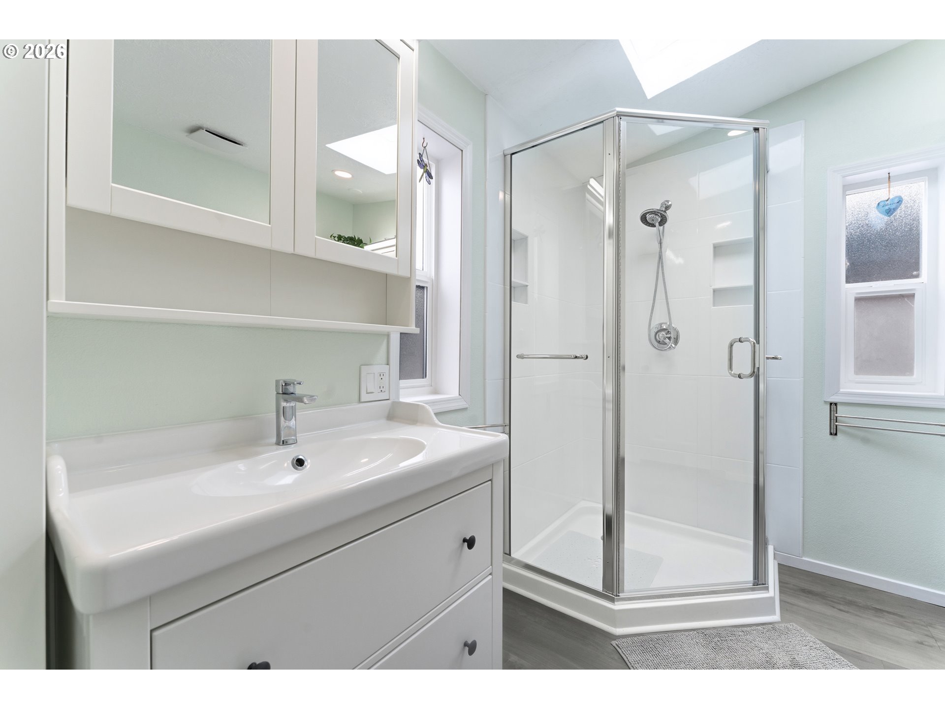 15768 Southeast Powell Boulevard, Unit 40 Portland, OR 97236 - Photo 17 of 33 a bathroom with a sink a mirror a shower and vanity