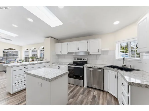 a kitchen with a sink stove and cabinets