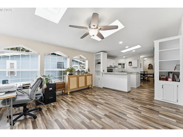 a living room with furniture and kitchen view