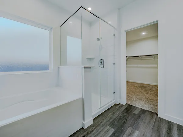 a bathroom with a glass shower door