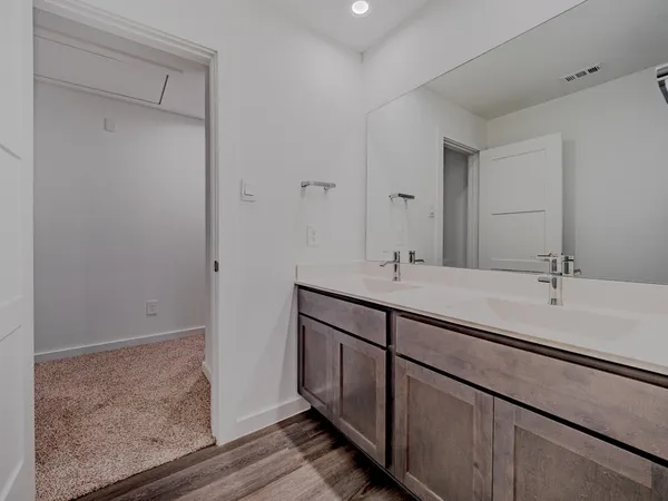 a bathroom with a double vanity sink and a mirror