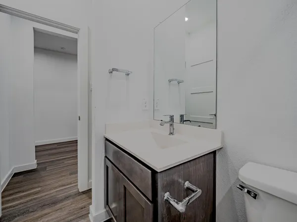 a bathroom with a sink a toilet and a mirror