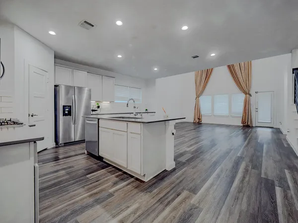 a view of kitchen with cabinets and wooden floor