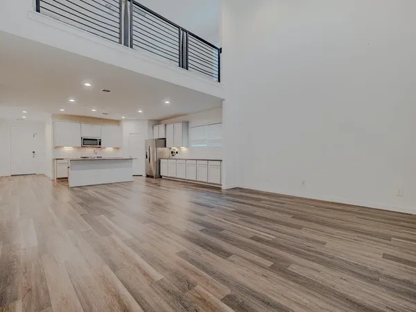 a view of kitchen with kitchen island wooden floor and center island