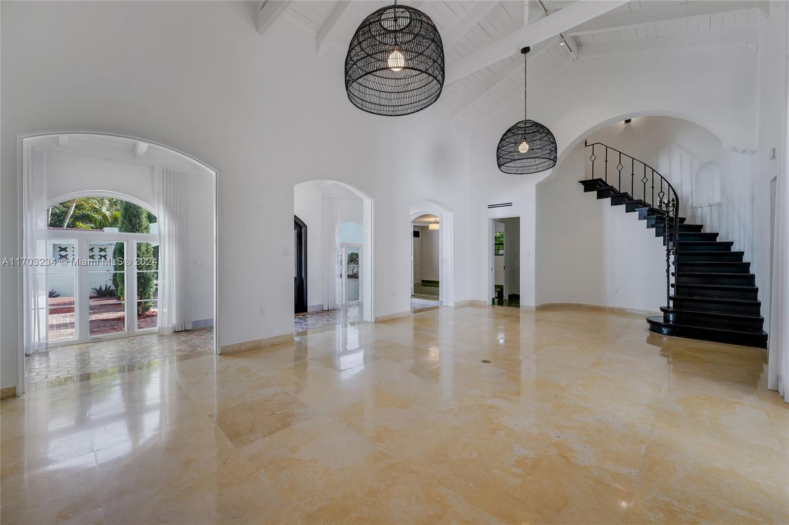 5660 Pine Tree Drive Miami Beach, FL 33140 - Photo 6 of 24 a view of a hallway with entryway wooden floor and a rug