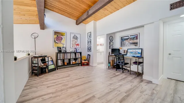 a view of a room with furniture and wooden floor