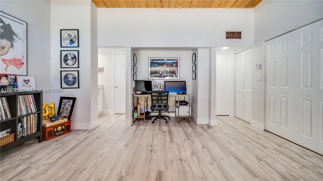 a view of a workspace with furniture and wooden floor