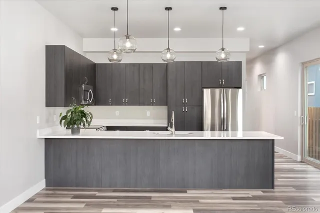 a living room with kitchen island furniture and a ceiling fan