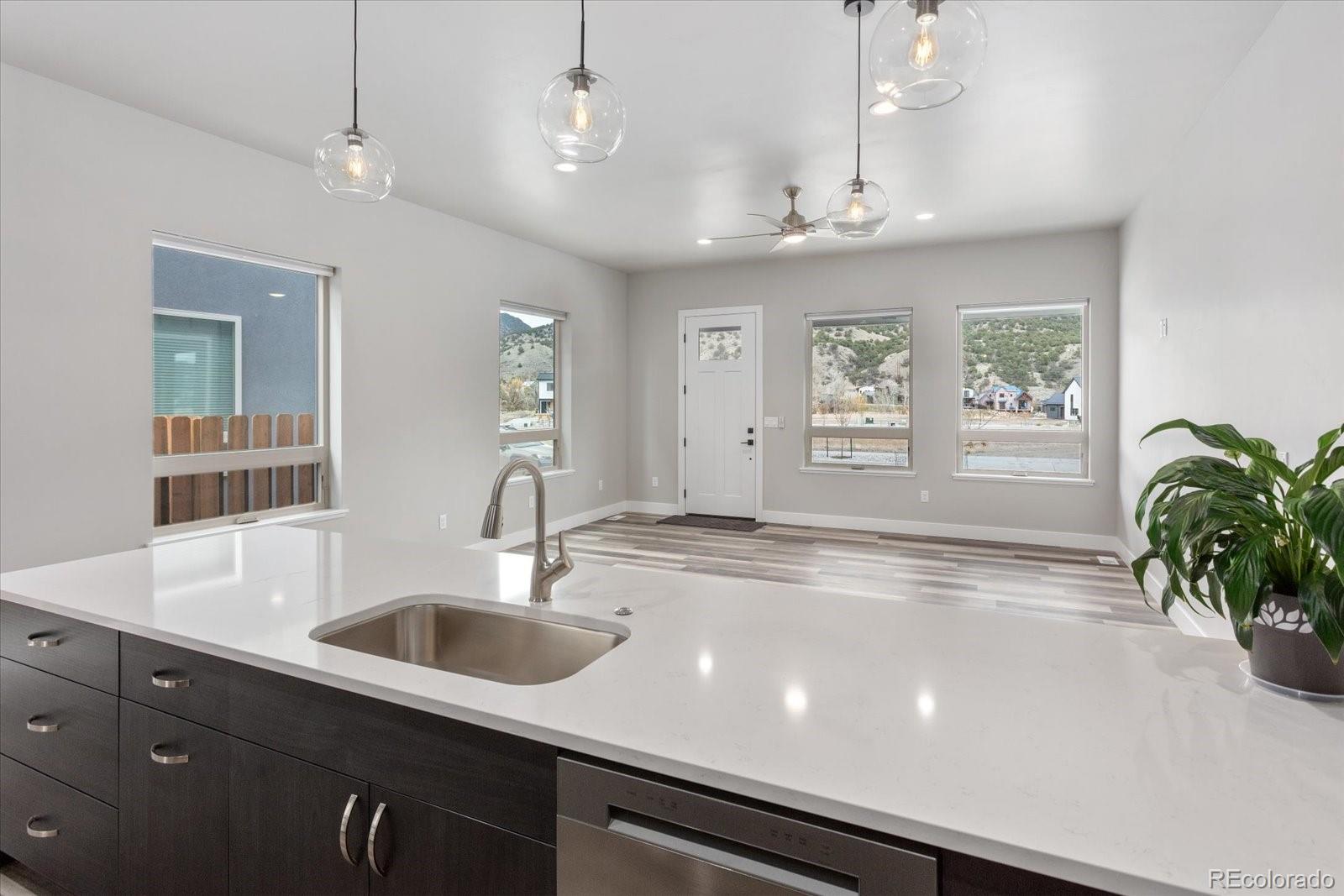 126 Southside Loop Salida, CO 81201 - Photo 11 of 29 a kitchen with stainless steel appliances a sink a counter space and a chandelier