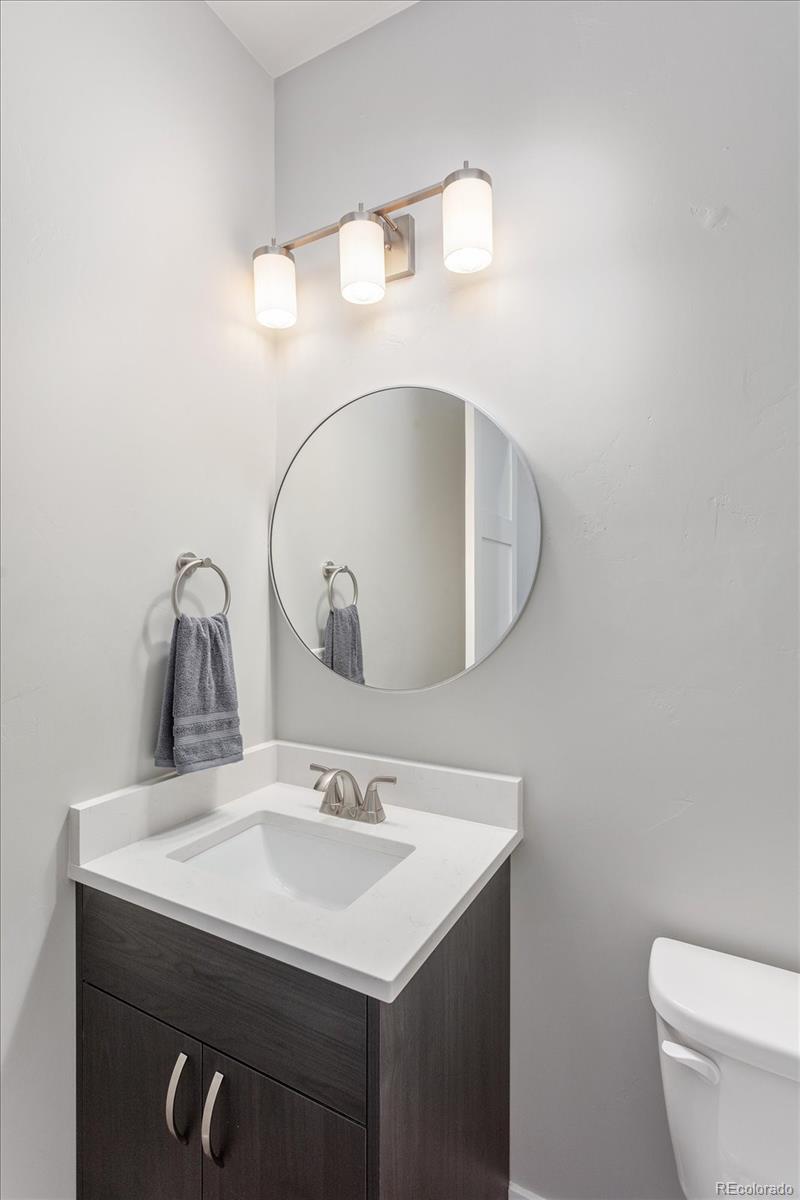 126 Southside Loop Salida, CO 81201 - Photo 12 of 29 a bathroom with a sink a toilet and a mirror