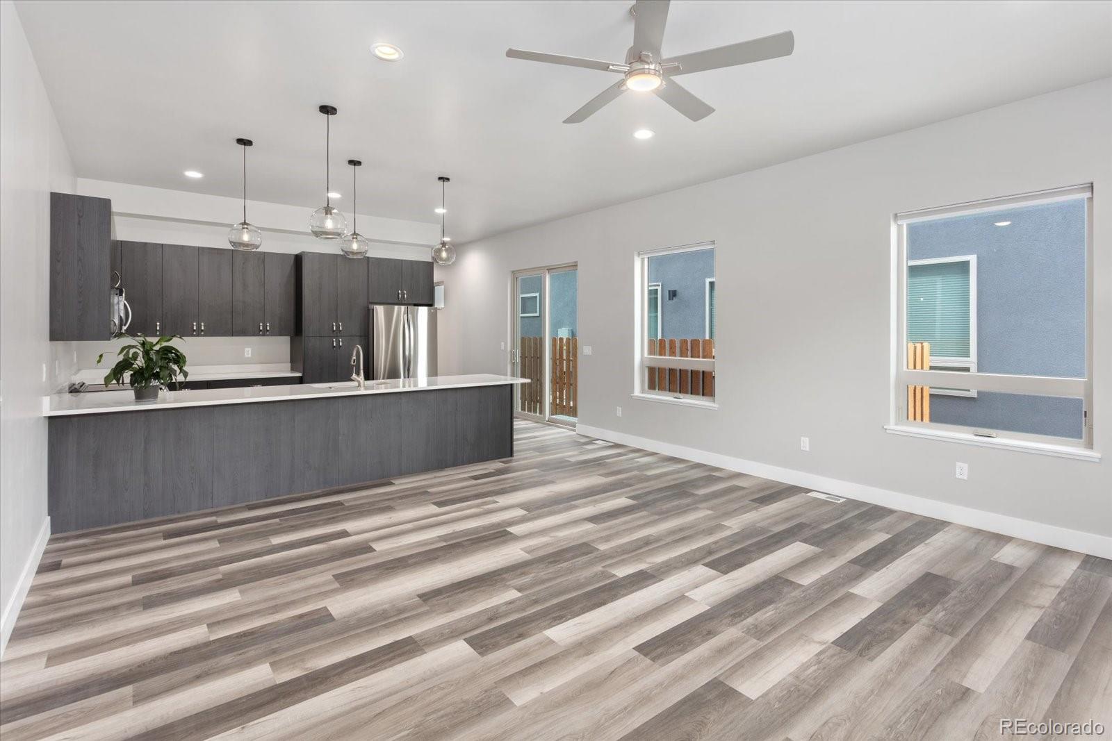 126 Southside Loop Salida, CO 81201 - Photo 2 of 29 a living room with kitchen island furniture and a ceiling fan
