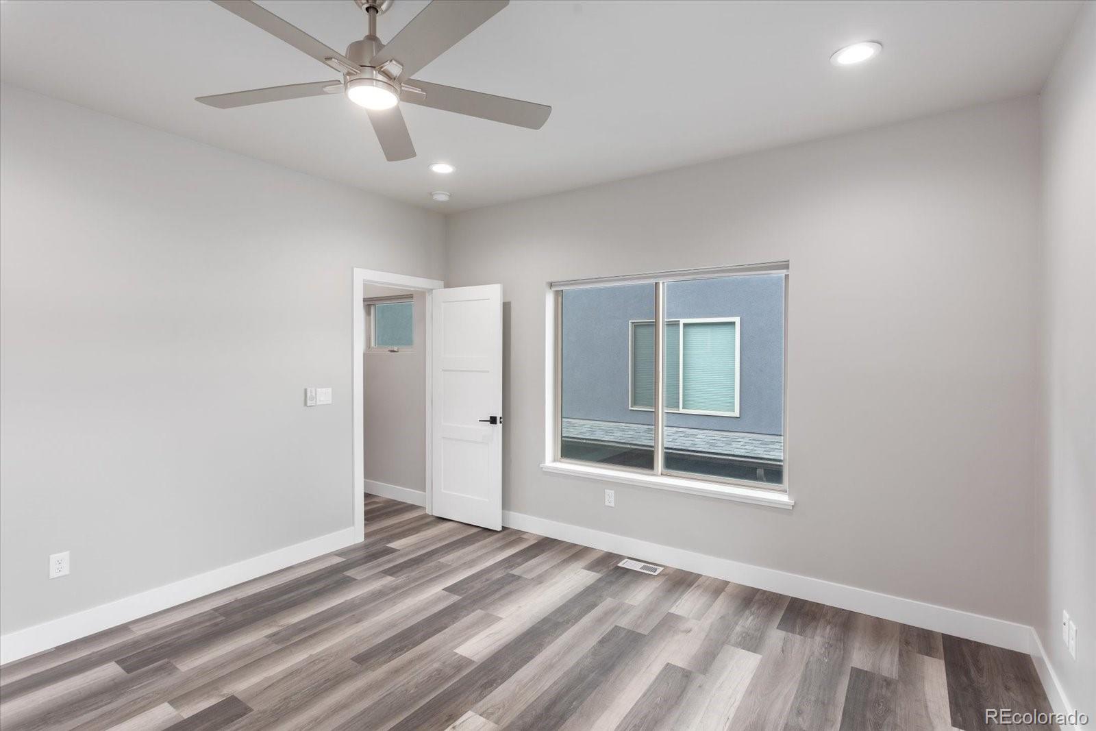 126 Southside Loop Salida, CO 81201 - Photo 21 of 29 a view of an empty room with a window and a kitchen