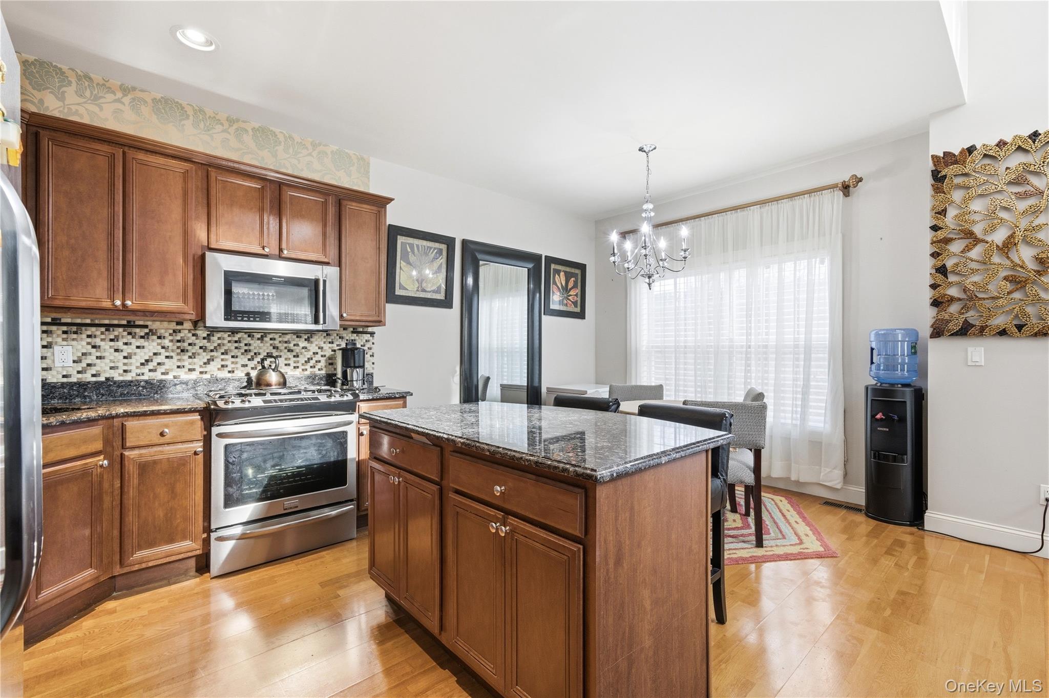 307 Medea Way Central Islip, NY 11722 - Photo 11 of 33 a kitchen with stainless steel appliances granite countertop a sink stove and refrigerator
