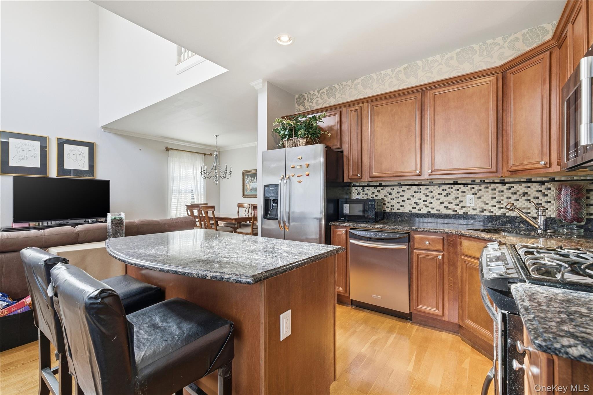 307 Medea Way Central Islip, NY 11722 - Photo 12 of 33 a kitchen with stainless steel appliances granite countertop a stove top oven a sink a refrigerator and a microwave