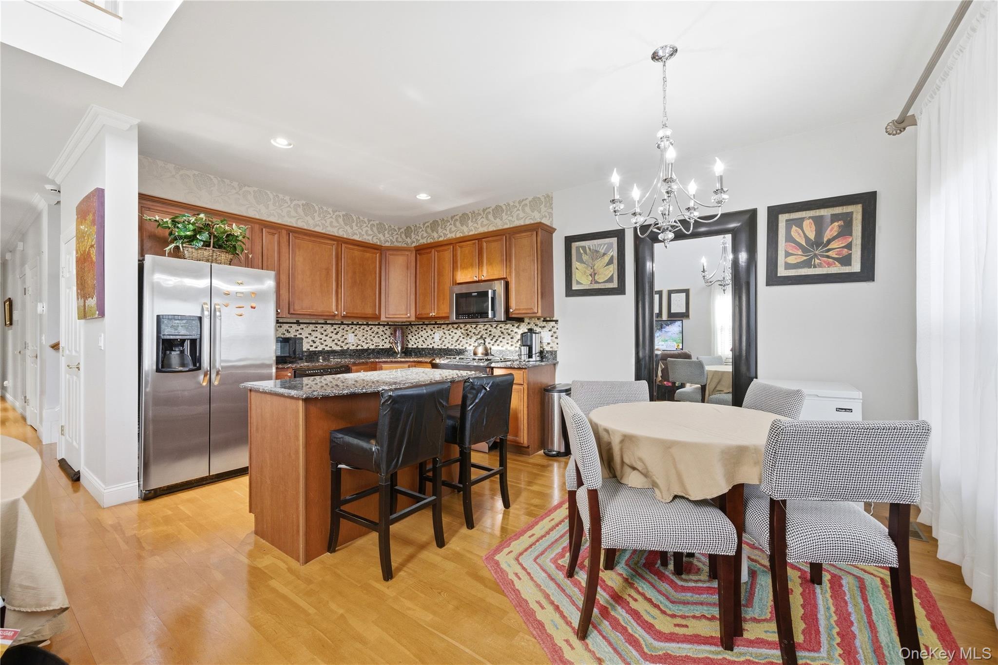 307 Medea Way Central Islip, NY 11722 - Photo 14 of 33 a view of a dining room with furniture a chandelier and kitchen view
