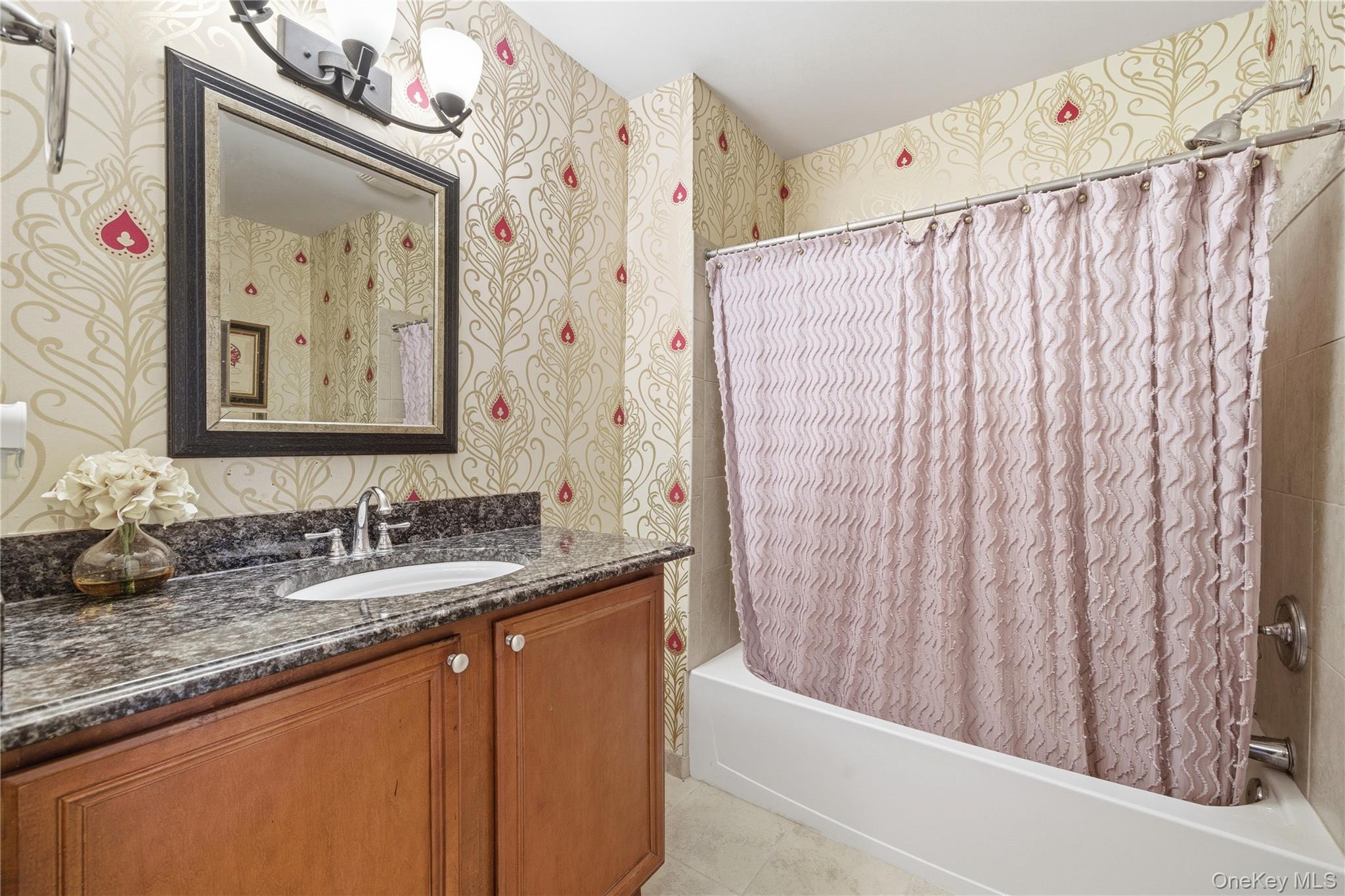 307 Medea Way Central Islip, NY 11722 - Photo 18 of 33 a bathroom with a granite countertop sink a mirror and a shower curtain