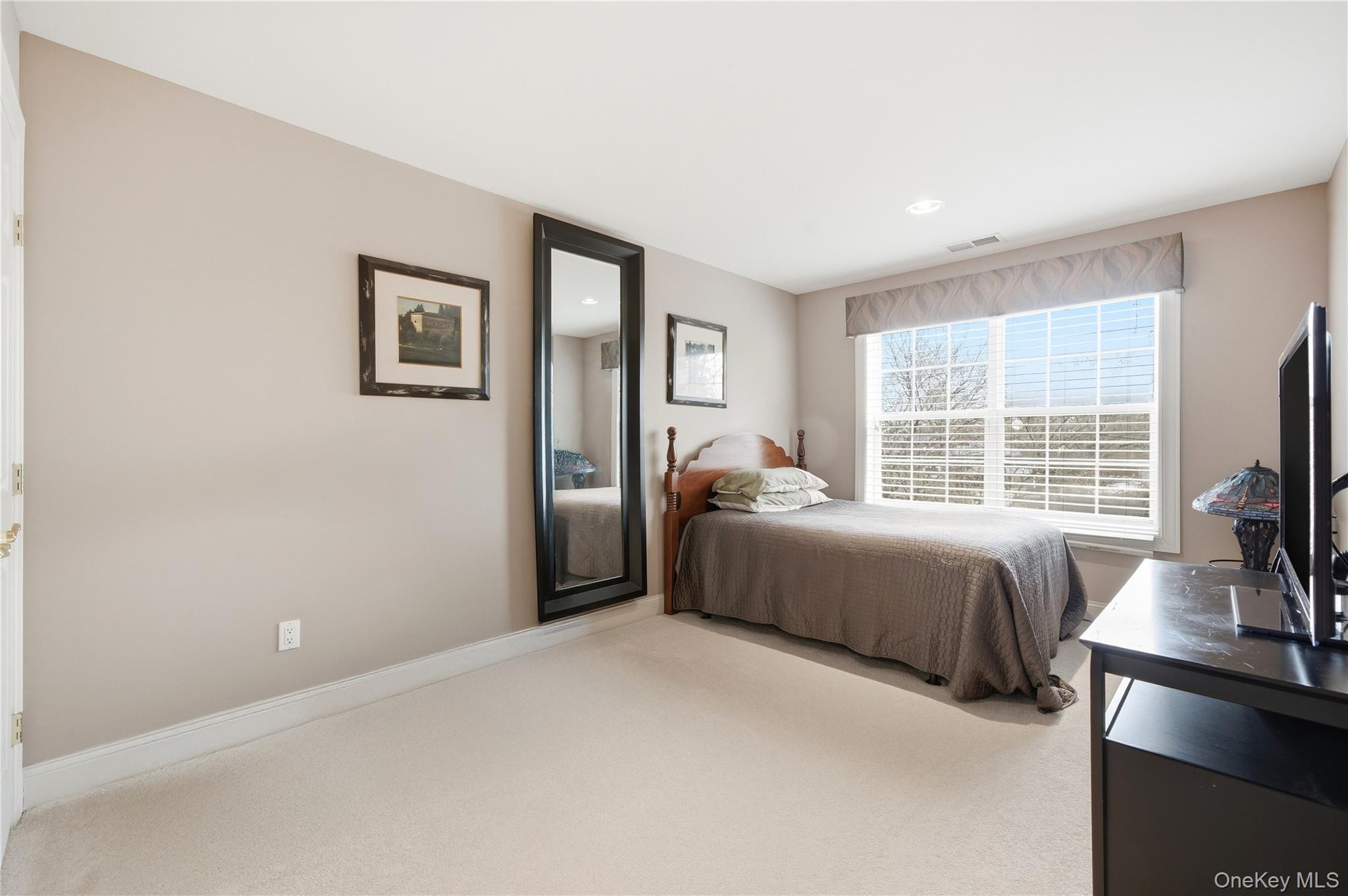 307 Medea Way Central Islip, NY 11722 - Photo 20 of 33 a bedroom with a bed and a flat screen tv