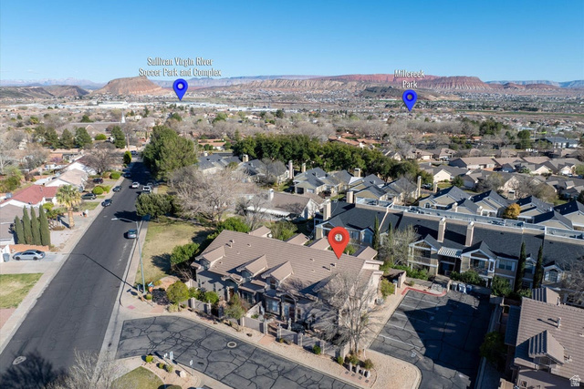 345 North 2450th Street East, Unit 152 St. George, UT 84790 - Photo 30 of 40 Aerial view of property and surrounding area with a mountainous background and nearby suburban area