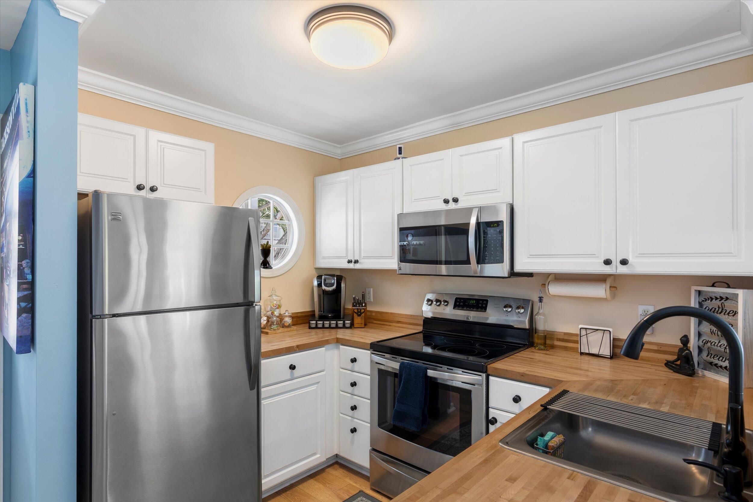 37 Spoonbill Way Key West, FL 33040 - Photo 11 of 88 a kitchen with stainless steel appliances granite countertop a refrigerator sink and stove