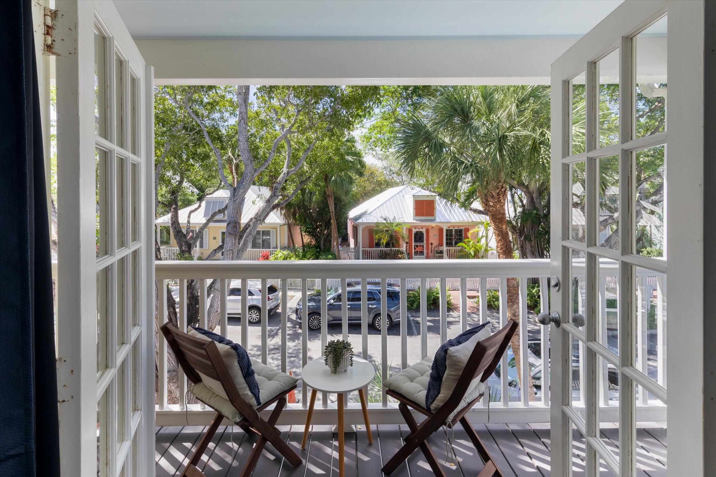 37 Spoonbill Way Key West, FL 33040 - Photo 53 of 88 a view of a balcony with chairs and wooden floor