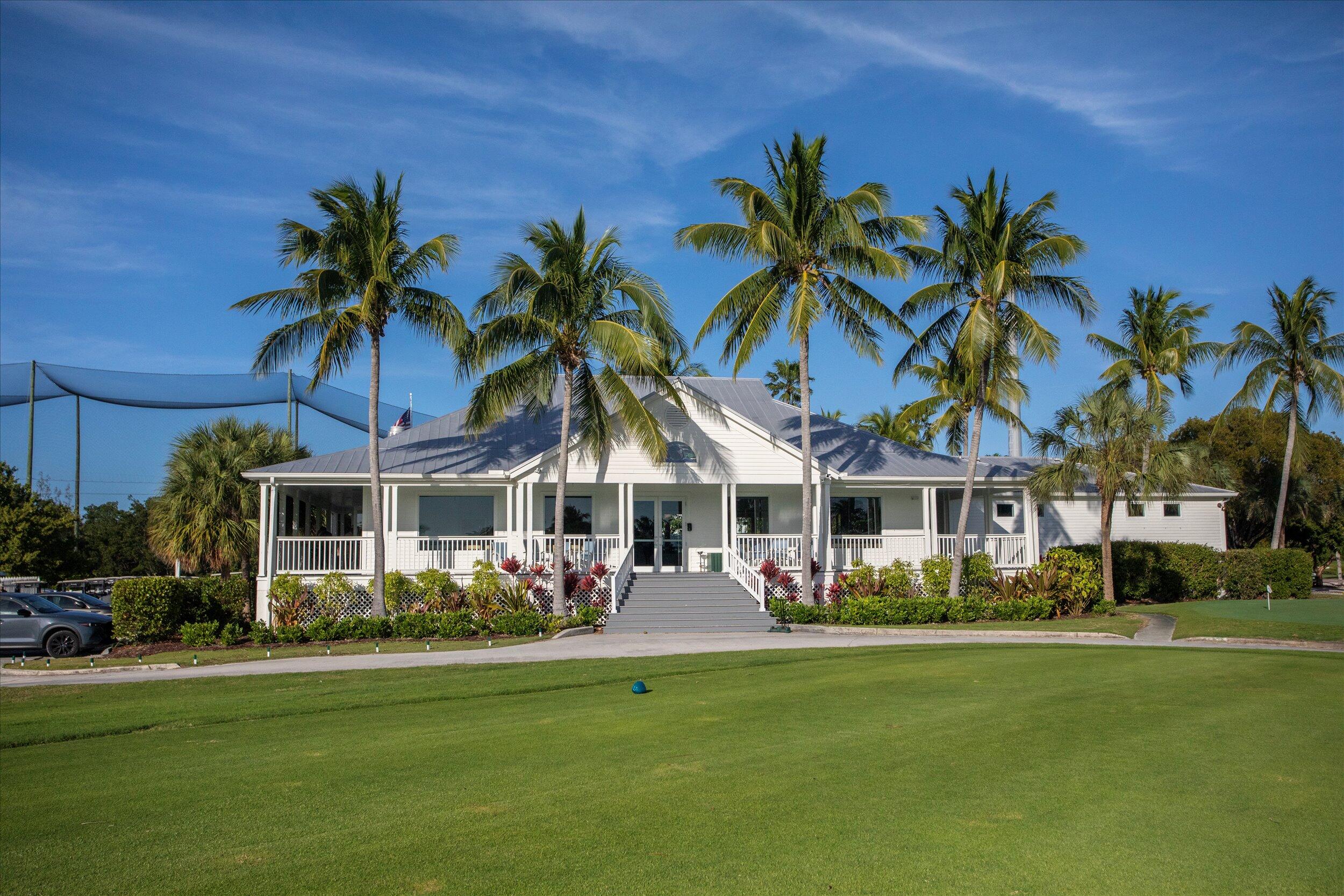 37 Spoonbill Way Key West, FL 33040 - Photo 59 of 88 a view of a swimming pool with lawn chairs under palm trees